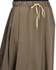 khaki nylon midi skirt with front pleats, drawstring waistband, and hidden side pockets, styled with a black top and woven sandals