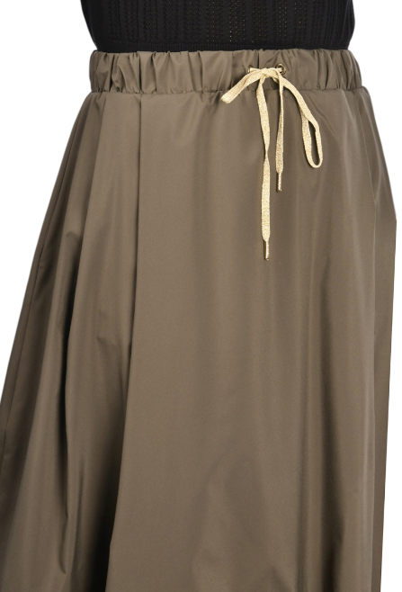 khaki nylon midi skirt with front pleats, drawstring waistband, and hidden side pockets, styled with a black top and woven sandals