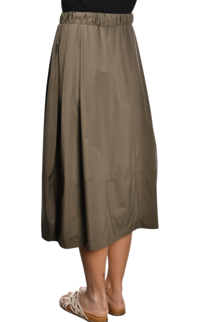 khaki nylon midi skirt with front pleats, drawstring waistband, and hidden side pockets, styled with a black top and woven sandals