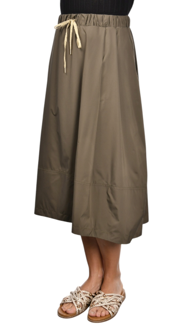 khaki nylon midi skirt with front pleats, drawstring waistband, and hidden side pockets, styled with a black top and woven sandals